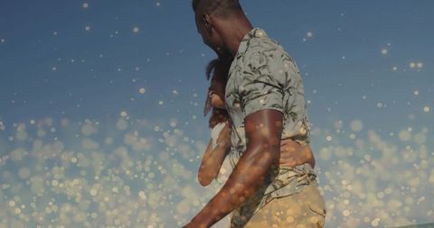 Romantic Couple Embracing by Peaceful Beach with Sparkling Bokeh