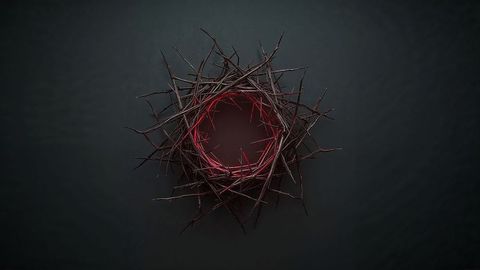 Thorny twig crown nest with red inner glow on dark surface