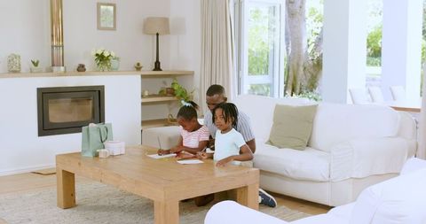 Children Engaging in Creative Crafts with Parent at Home