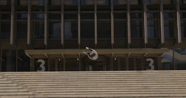 Urban Parkour Athlete Performing Backflip on Concrete Stairs - Download Free Stock Images Pikwizard.com