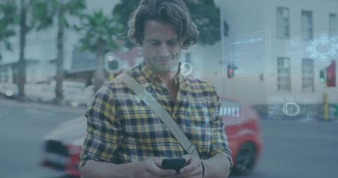 Man checking smartphone with AR interface on city crossing wearing yellow plaid shirt