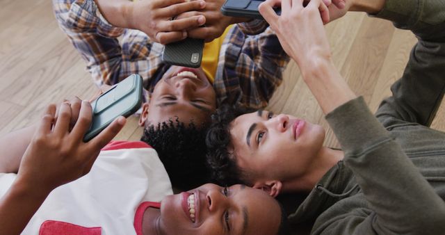 Teenagers Relaxing Together on Floor, Interacting with Smartphones - Download Free Stock Images Pikwizard.com