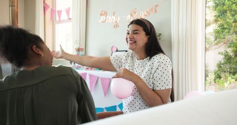 Joyful Women Preparing for Baby Shower Celebration