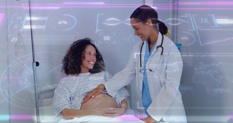 Doctor palpating pregnant belly and monitoring fetal health during prenatal checkup