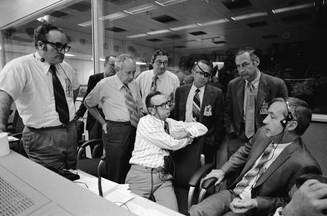 S72-37009 (20 April 1972) --- NASA officials gather around a console in the Mission Operations Control Room (MOCR) in the Mission Control Center (MCC) prior to the making of a decision whether to land Apollo 16 on the moon or to abort the landing. Seated, left to right, are Dr. Christopher C. Kraft Jr., Director of the Manned Spacecraft Center (MSC), and Brig. Gen. James A. McDivitt (USAF), Manager, Apollo Spacecraft Program Office, MSC; and standing, left to right, are Dr. Rocco A. Petrone, Apollo Program Director, Office Manned Space Flight (OMSF), NASA HQ.; Capt. John K. Holcomb (U.S. Navy, Ret.), Director of Apollo Operations, OMSF; Sigurd A. Sjoberg, Deputy Director, MSC; Capt. Chester M. Lee (U.S. Navy, Ret.), Apollo Mission Director, OMSF; Dale D. Myers, NASA Associate Administrator for Manned Space Flight; and Dr. George M. Low, NASA Deputy Administrator.  Photo credit: NASA