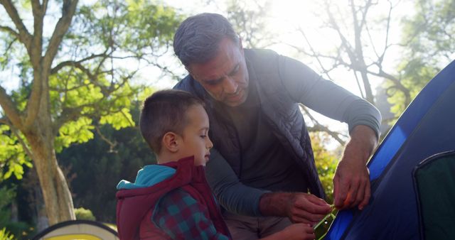 Father and Son Setting Up Tent in Forest - Download Free Stock Images Pikwizard.com