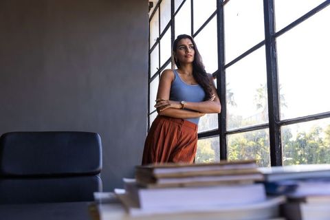 Confident woman standing in modern office interior