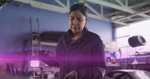 Mechanic Woman in Garage with Serious Expression