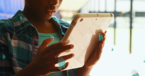 African american girl using digital tablet with floating icons