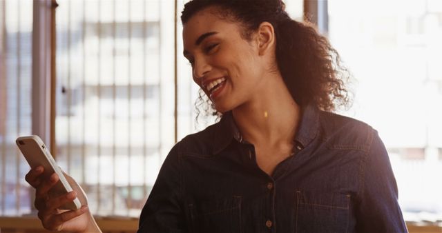 Smiling Woman Using Smartphone in Modern Office - Download Free Stock Images Pikwizard.com