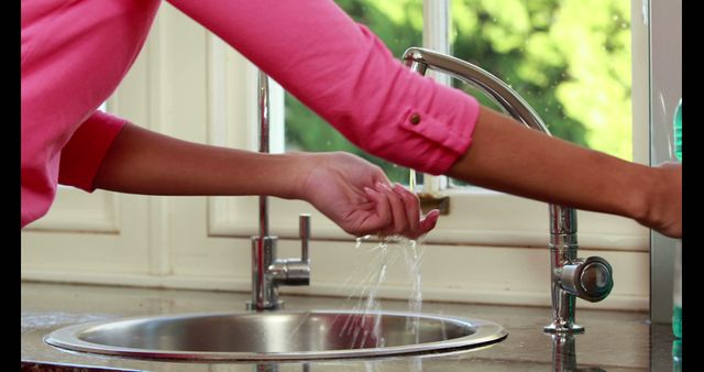 Person Washing Hands in Kitchen Sink - Download Free Stock Images Pikwizard.com