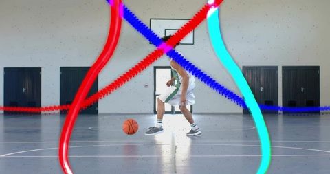 Basketball Athlete Dribbling Amidst Colorful Motion Effects