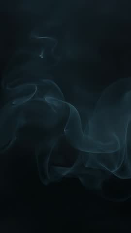 Ethereal smoke plume rising and twisting in dark moody vertical video abstract atmospheric