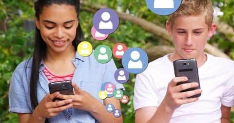 Teenagers Communicating with Smartphones Outdoors