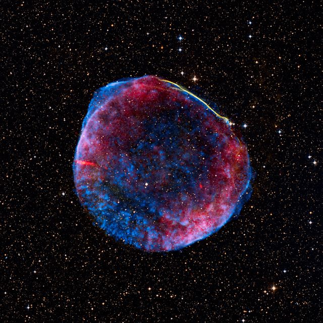 This composite image showcases the remnant of the SN 1006 supernova, combining optical, radio, and X-ray data. Captured on July 1, 2008, its impressive display includes optical data from Cerro Tololo Inter-American Observatory, X-ray observations from Chandra X-ray Observatory, and radio data from the National Radio Astronomy Observatory. With an angular size equivalent to the full moon, measuring 60 light-years in physical diameter and located around 7,000 light-years from Earth, this extraordinary view could be used to illustrate cosmic phenomena in educational materials, science documentaries, and astronomical publications. This image is credited to NASA, ESA, and several contributing astrophysicists and observatories.