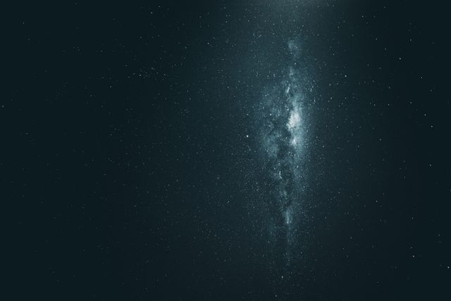 Mysterious glowing galaxy shines in deep space amidst a backdrop of stars. Perfect for use in astronomy-related content, cosmic artwork, sci-fi themes, educational materials, or desktop wallpapers. Ideal background for creating awe-inspiring designs that focus on the beauty and vastness of the universe.