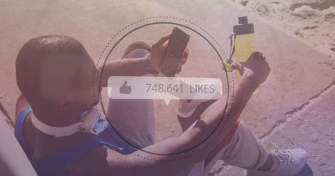 Man Engaging with Social Media During Beach Workout