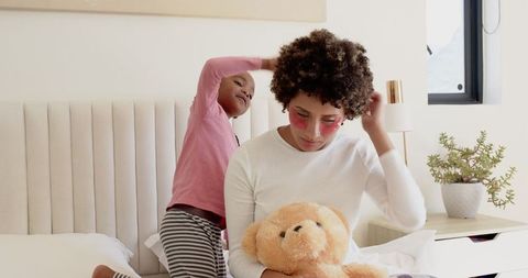 Mother and Daughter Bonding while Styling Hair and Playing with Toys