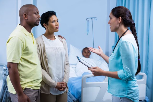 Doctor interacting with patient parents in hospital