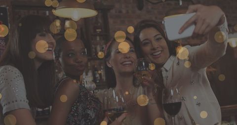 Smiling Female Friends Taking a Selfie at Party with Festive Lighting