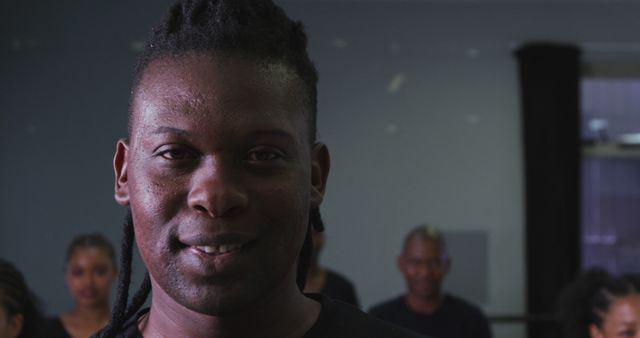 Confident Person with Dreadlocks Smiling Indoors in Group Setting - Download Free Stock Images Pikwizard.com