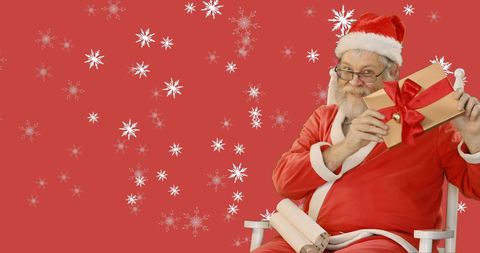 Santa Claus Holding Gift in Snowflake Background for Christmas Celebration