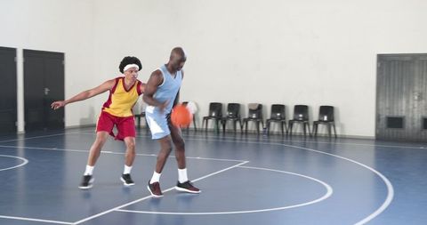 Intense basketball practice defensive drill indoor court