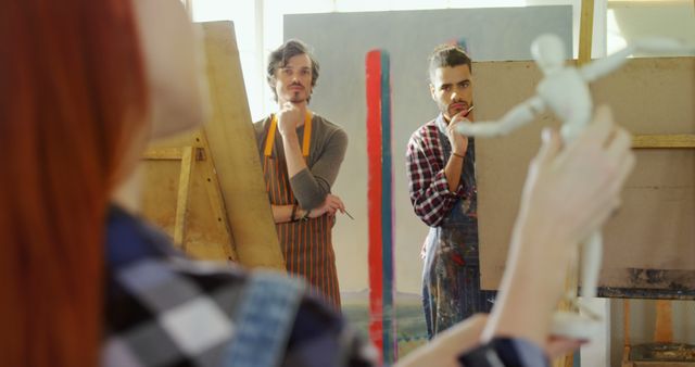 Art students attentively observing life drawing class with wooden mannequin - Download Free Stock Images Pikwizard.com