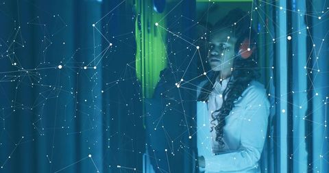 Two IT Technicians Examining Server Racks with Digital Network Overlay