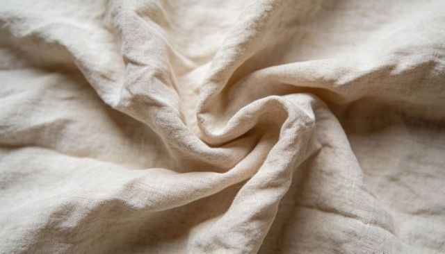 Beige linen spiral fold macro texture for textile design, home decor, background