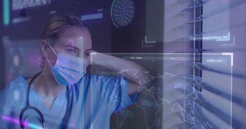 Nurse wearing mask and stethoscope studying ar medical data overlays