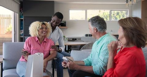 Senior Couple Enjoys Heartwarming Celebration with Friends at Home