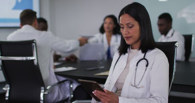 Female Doctor Using Tablet in Hospital Meeting Room - Download Free Stock Images Pikwizard.com