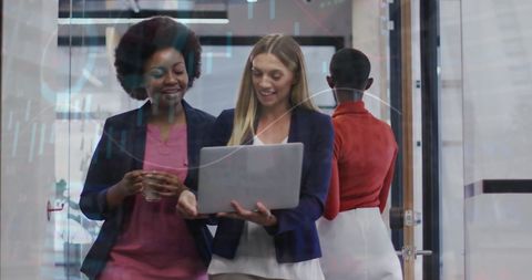 Diverse businesswomen analyzing digital finance data together