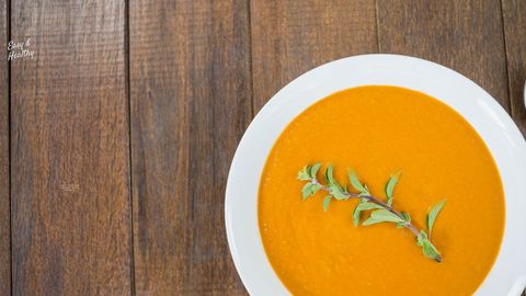 pumpkin soup with herb garnish on rustic wooden table - Download Free Stock Templates Pikwizard.com