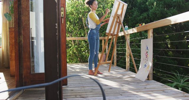 Biracial woman painting on canvas in the balcony at home - Download Free Stock Photos Pikwizard.com