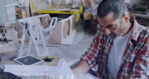 Man Analyzing Business Data in Workshop