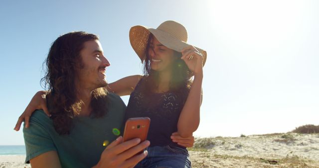 Couple Enjoying Beach with Smartphone in Sunshine - Download Free Stock Images Pikwizard.com