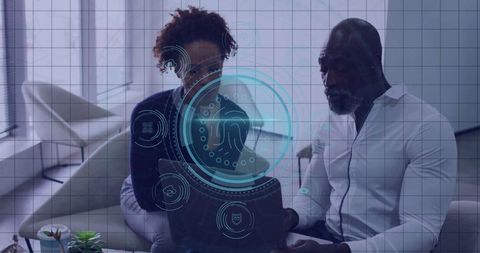 Business Professionals Analyzing Digital Interface on Laptop