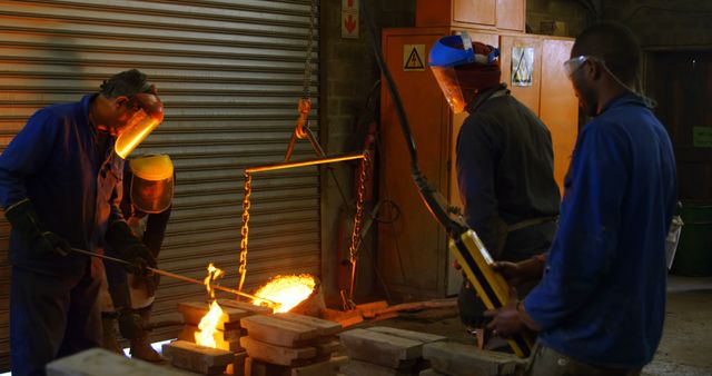 Foundry Workers Melting Metal with Heavy Machinery - Download Free Stock Images Pikwizard.com