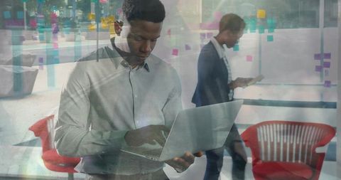 Businessman typing on laptop with transparency effect