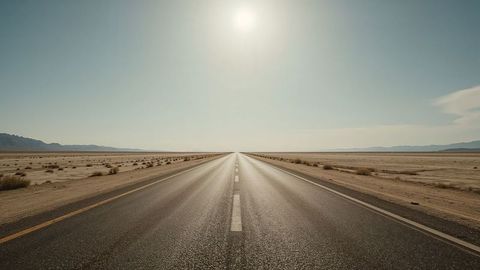 Two-lane Highway Stretching Across Desert Plains Under Sun