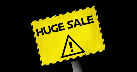 Bright yellow huge sale promo sign on black background