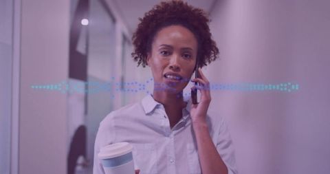 Professional Woman Communicating on Phone in Modern Office Environment