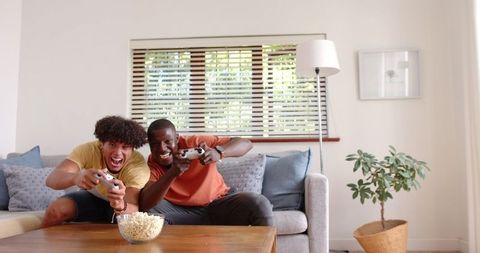 Diverse Male Friends Enjoying Video Game at Home with Popcorn