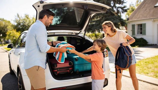 Family loading luggage into suv for summer road trip in sunny suburban neighborhood