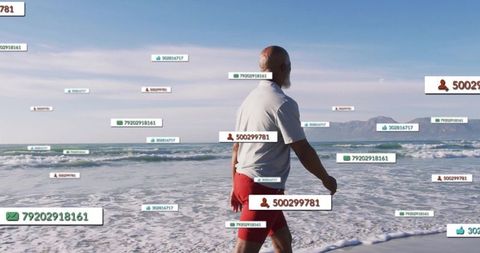 Man Walking on Beach Exploring Digital Data Interface