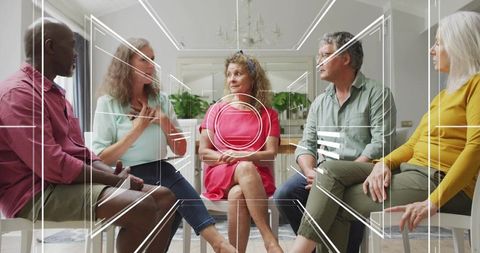 Diverse adults sharing and listening in support group circle in bright living room