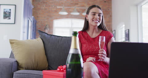 Woman Enjoying Valentine's Day Video Call with Champagne