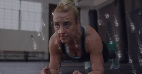 Focused Woman Holding Plank with Digital Binary Coding Overlay
